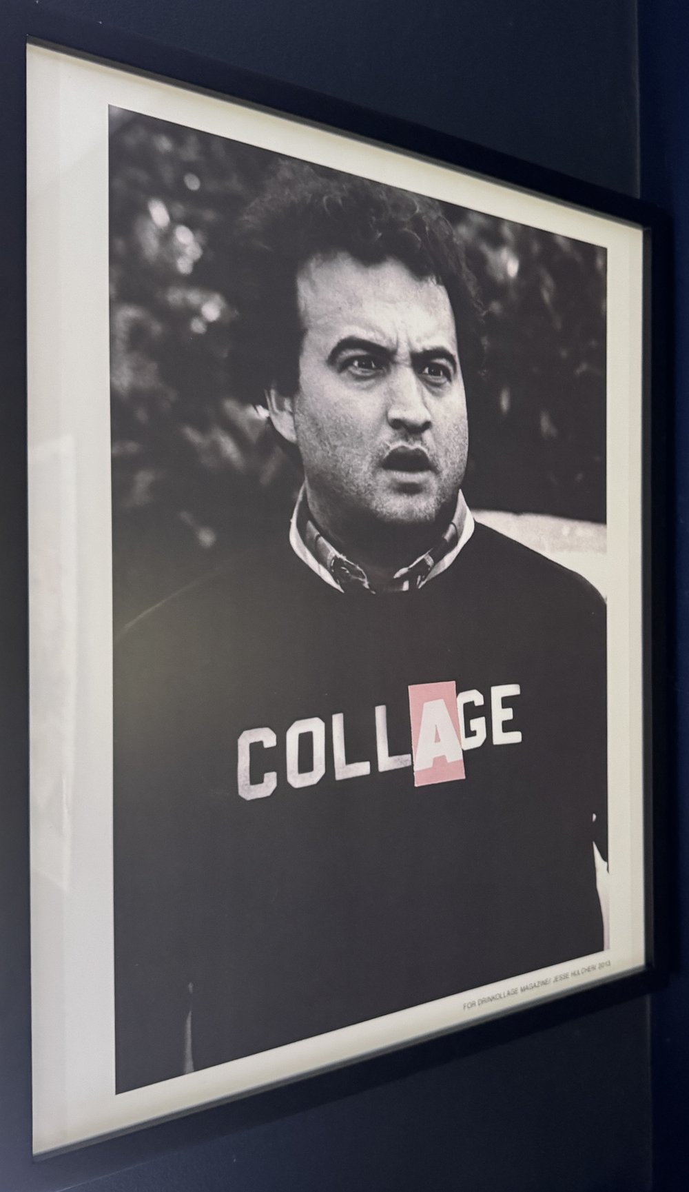 Framed print of John Belushi in a COLLAGE sweatshirt, after Animal House